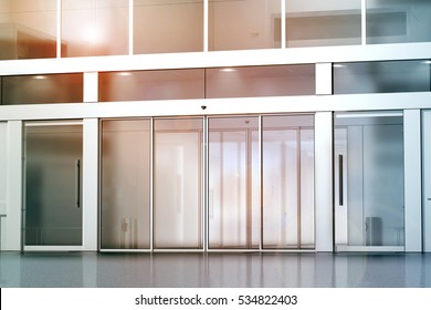 Blank Sliding Glass Doors Entrance Mockup, 3d Rendering. Commercial Building Entry Mock Up. Office Exterior Outdoor Template. Emporium Facade On Sunset, Front View. Sunny Shopping Center.