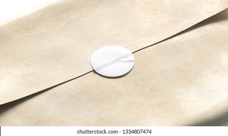 Blank white adhesive round sticker on craft wrapping paper mockup, 3d rendering. Empty delivery pack with glue stick mock up. Clear product crumpled package with badge template.