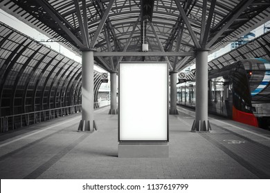 Blank white banner at metro station with arrived train on a background. Train is out of focus and blurred, banner is on focus. Station is monochrome and train is coloured. 3d rendering