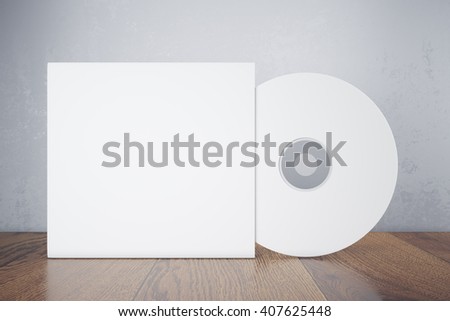 Blank white compact disk with cover on wooden table and concrete wall background. Mock up, 3D Rendering