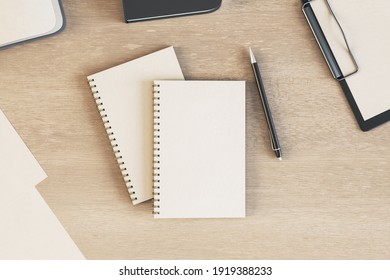 Blank white diaries cover with pen on light wooden table. Mockup. 3D rendering