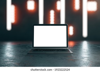 Blank white laptop display on dark concrete surface with abstract blurry nights lights background. Mockup. 3D rendering