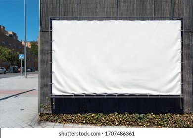Blank White Outdoor Horizontal Vinyl Textile Banner at Wooden Wall of Modern Building. Copy Space. Empty Space. 3d rendering.