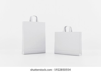 Blank white paper bags with a space for your logo. Mockup. 3D rendering