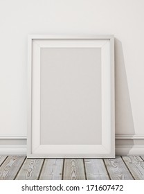 Blank White Picture Frame On The White Wall And The Wooden Floor, Background