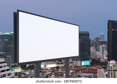 Blank white road billboard with Bangkok cityscape background at sunset. Street advertising poster, mock up, 3D rendering. Side view. The concept of marketing communication to promote or sell idea. - Shutterstock ID 1807083073