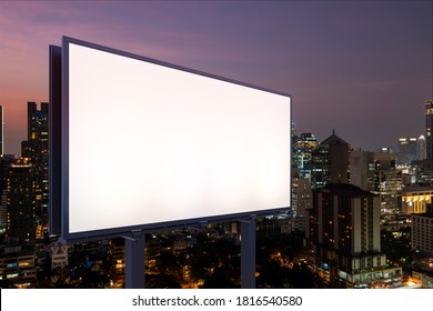 Blank White Road Billboard With Bangkok Cityscape Background At Night Time. Street Advertising Poster, Mock Up, 3D Rendering. Side View. The Concept Of Marketing Communication To Sell Idea.