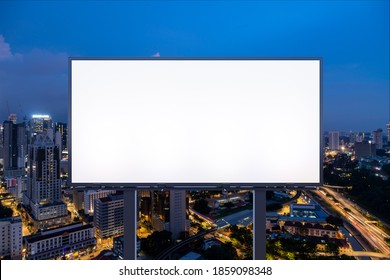 Blank white road billboard with KL cityscape background at night time. Street advertising poster, mock up, 3D rendering. Front view. The concept of marketing communication to promote or sell idea. - Powered by Shutterstock