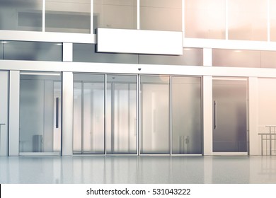 Blank white signage on the store glass doors entrance mockup, 3d rendering. Commercial building automatic entry, banner mock up. Closed transparent business centre facade, front view.