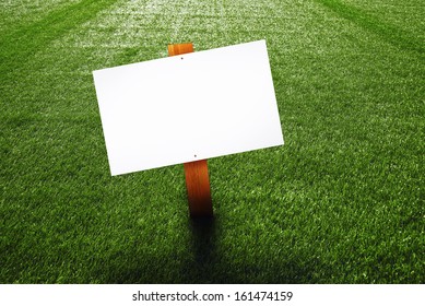 Blank Wooden Sign On Green Lawn For Your Message.