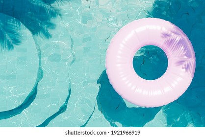 Blue Bottom Pool With Round Stairs Seen From Above With A Pink Float And Shade Of Palm Trees. 3d Render