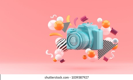 Blue camera surrounded by colorful balls on a pink background.-3d render. - Powered by Shutterstock