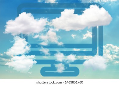 Blue Computer Icon On Dramatic Blue Sky Partly Covered With Clouds. Concept Of Cloud Computing And Other Modern Technologies.