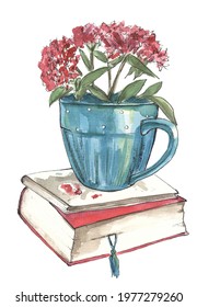 blue cup with flowers on a stack of books