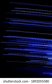 blue dashed lines of lights on a black background