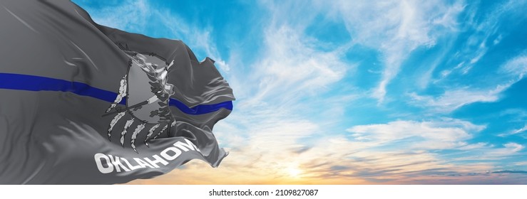 Blue Line Flag Of Oklahoma State, Usa At Cloudy Sky Background On Sunset, Panoramic View. United States Of America Police Flag. Copy Space For Wide Banner. 3d Illustration