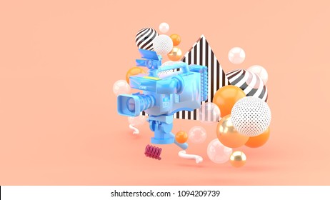 A Blue Video Camera Surrounded By Colorful Balls On A  Pink Background.-3d Render.