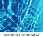 Blue water with ripples on the surface. Defocus blurred transparent blue colored clear calm water surface texture with splashes and bubbles. Water waves with shining pattern texture background.