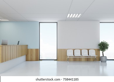 Blue And Wooden Hospital Lobby With A Reception Desk And White Chairs For Patients Waiting For The Doctor Visit. 3d Rendering Mock Up