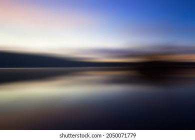 Blur Background Of Colorful Blue Sky Over The Nature Lake With Smooth Water Reflection. New Day, New Beginning Concept For Inspirational Or Motivational Backgrounds. Copy Space.