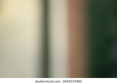 Blurred abstract background, vertical stripes of dark green and light beige. Muted, pastel tones