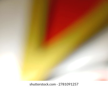 A blurred abstract image with bold diagonal lines of red, yellow, and white, creating a sense of motion and energy.