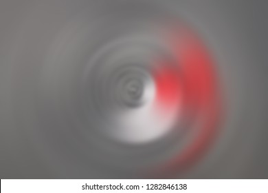 
Blurred background in gray with red and white spots in the shape of a circle.