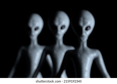Blurred Background Row of Scary Gray Humanoid Aliens on a black background. 3d Rendering 