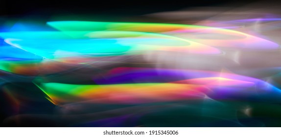 Blurred Light Painting One Exposure In Camera. Light Glares With A Spectral Gradient On A Dark Background. Multicolored Abstract Colorful Line. Unusual Light Effect.