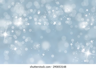 Blurry Abstract Bokeh Lights On Light Blue Background With Sparkle.