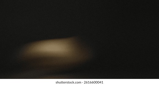A blurry image showing a light source in a dark environment with a visible shadow on the surface