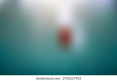 Blurry red object on a gradient teal background with a white light source