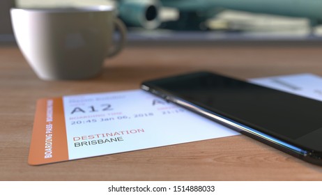 Boarding Pass To Brisbane And Smartphone On The Table In Airport While Travelling To Australia. 3D Rendering