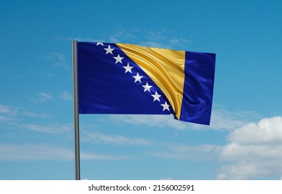 Bosnia and Herzegovina national flag waving in the wind. Sky background 3D illustration - Shutterstock ID 2156002591