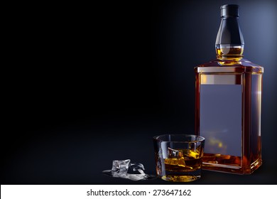 bottle and glass of whiskey with ice 