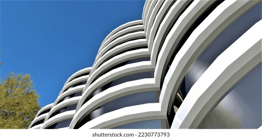 Bottom view of a modern building with a rounded facade. White concrete rings and mirrored glass walls. 3d rendering. - Powered by Shutterstock