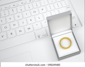 Box For Jewelry With Gold Ring On The Keyboard. View From Above