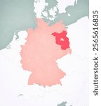 Brandenburg on the map of Germany with softly striped vintage background.