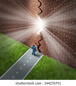 Breaking the wall business concept with a businessman using a sledge hammer to break through a huge brick obstacle creating a glowing crack showing hope and opportunity through confident leadership.