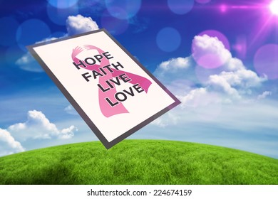 Breast cancer awareness message against green field under blue sky - Powered by Shutterstock