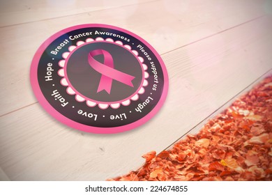 Breast cancer awareness message in pink against autumn leaves against white wood - Powered by Shutterstock