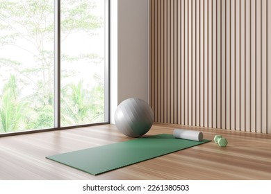 Bright fitness gym interior with exercise mat, ball and dumbbell. White wall, oak wooden floor, panoramic window. Concept of place for yoga, gymnastics, training, meditating. 3d rendering - Powered by Shutterstock