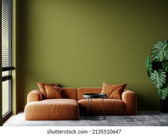 Bright livingroom with green olive empty walls and a large sofa. Accent orange ochre couch. Space mockup for art or picture. Modern interior design room. 3d rendering