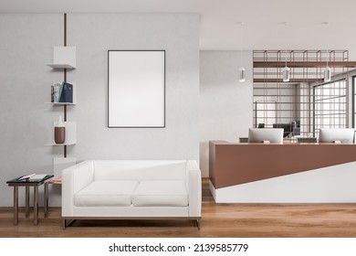 Bright Office Reception Room Interior With Empty White Poster, Sofa, Coffee Table, Desktops And Oak Wooden Floor. Concept Of Place For Working Process And Meeting. Mock Up. 3d Rendering