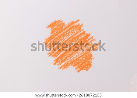 Bright orange crayon scribbled on a white surface. Crayon scribble texture isolated on white background.