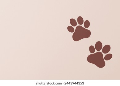 Brown pet paws on beige background, dog paws pattern. National Puppy Day creative concept, top view - Powered by Shutterstock