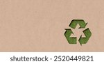 Brown recycled paper with cut out recycling symbol on grass background, eco, environment or recycling concept with copy space, 3D illustration