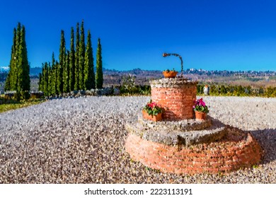 Brush Stroke Winter Landscape In Montepulciano With A Water Well In The Foreground (Tuscany, Siena, Italy).