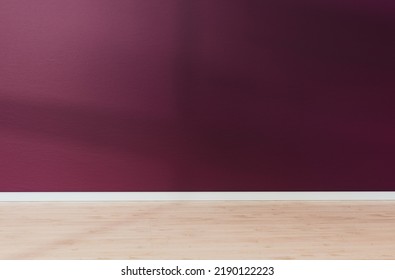 Burgundy Red Textured Wall And Light Wooden Floor In Empty Room For Displaying Your Product, Light Coming Through Window. 3D Illustration.