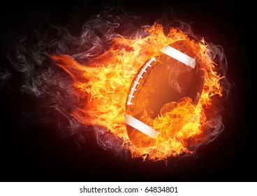 Burning Football Ball Enveloped In Fire Flame Isolated On Black Background. 